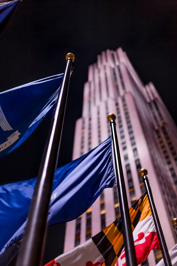Americas Tower and illuminated international flags at night; New York City, New York, United States of America