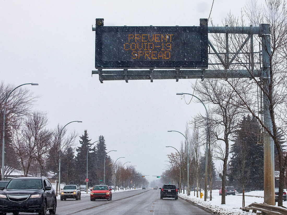Road sign reading 'Prevent Covid-19 Spread'; Edmonton, Alberta, Canada