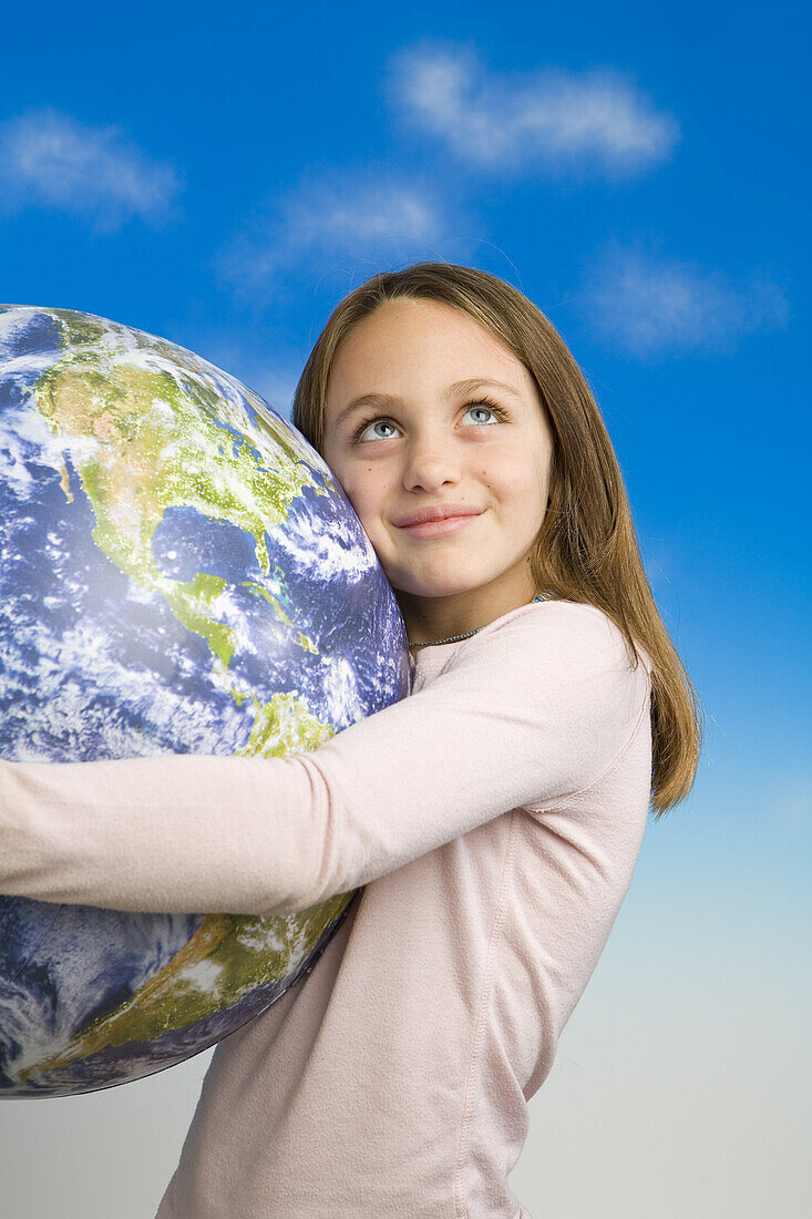 Little Girl Holding a Model of Earth as Seen From Outer Space