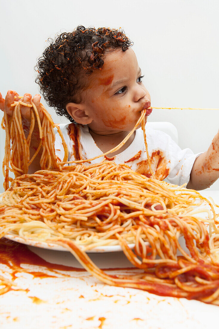 Boy eating Spaghetti with Hands