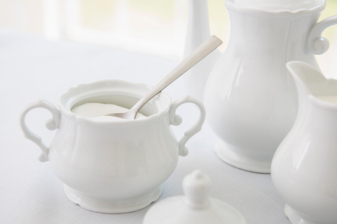 White porcelain sugar bowl with teapot and creamer, tea service, studio shot