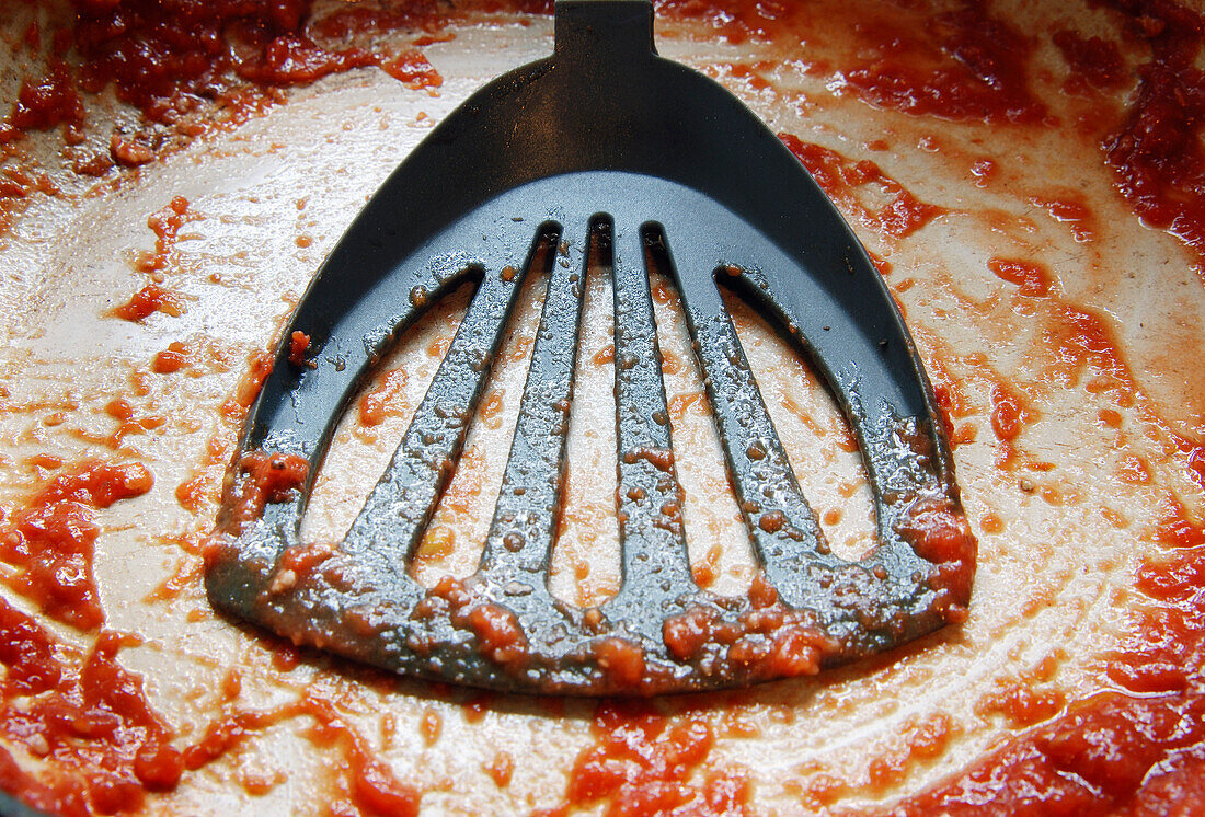 Spatula in Messy Frying Pan
