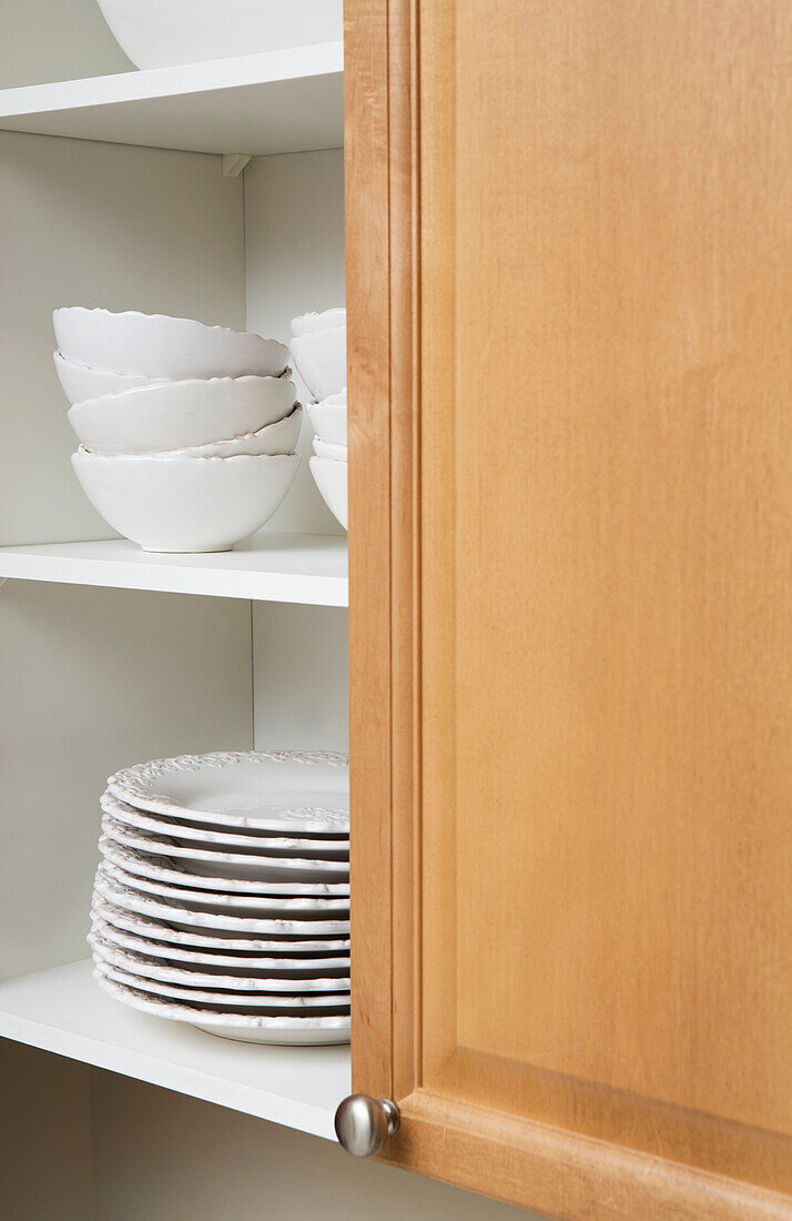 Stacked Dishes in Kitchen Cupboard