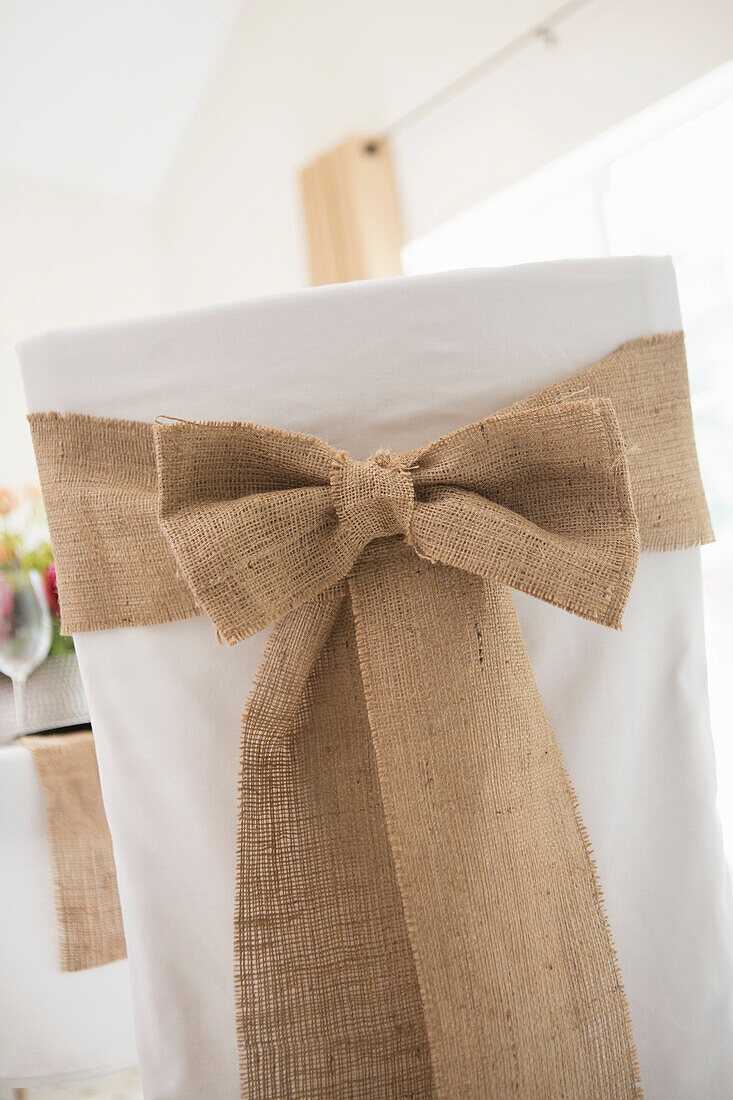 Back view of covered chair with sash for fine dining