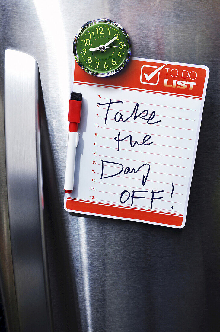 Close-up of Front of Stainless Steel Refridgerator with Magnetized To Do List