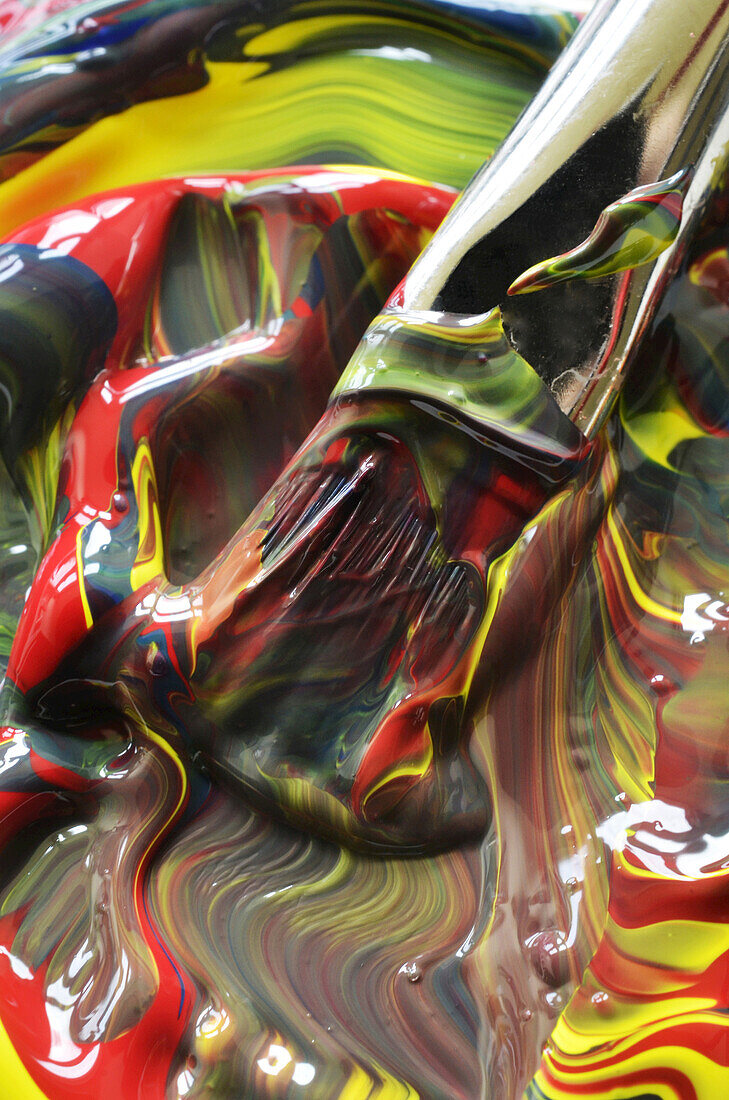 Close-up of paint swirls and brush