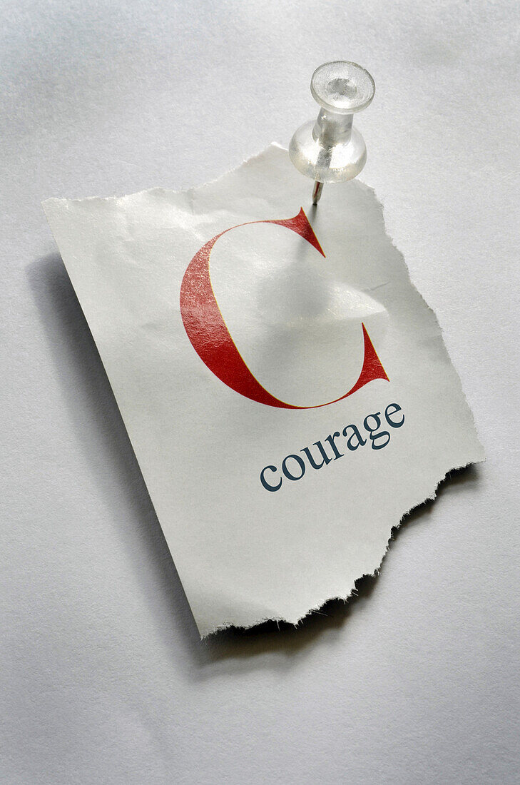 Close-up of Torn Page with C and Courage on it, Pinned to Board