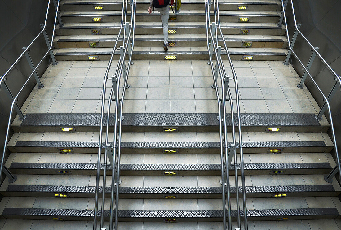 Train station stairs with metal railings at Paddington Station in London, England