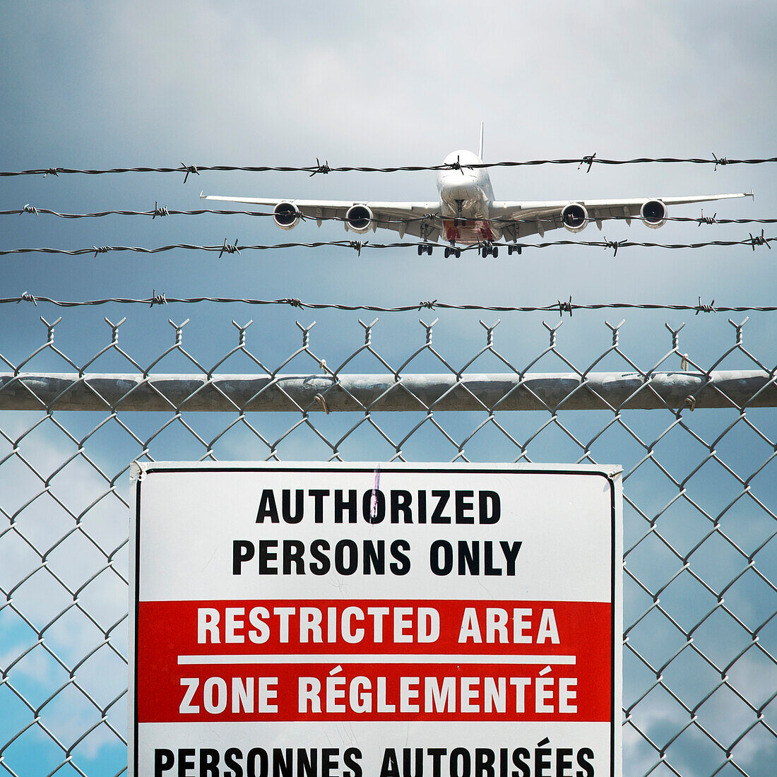Jumbo Jet and Restricted Area Sign on Chain Link Fence with Barbed Wire, Pearson International Airport, Toronto, Ontario, Canada