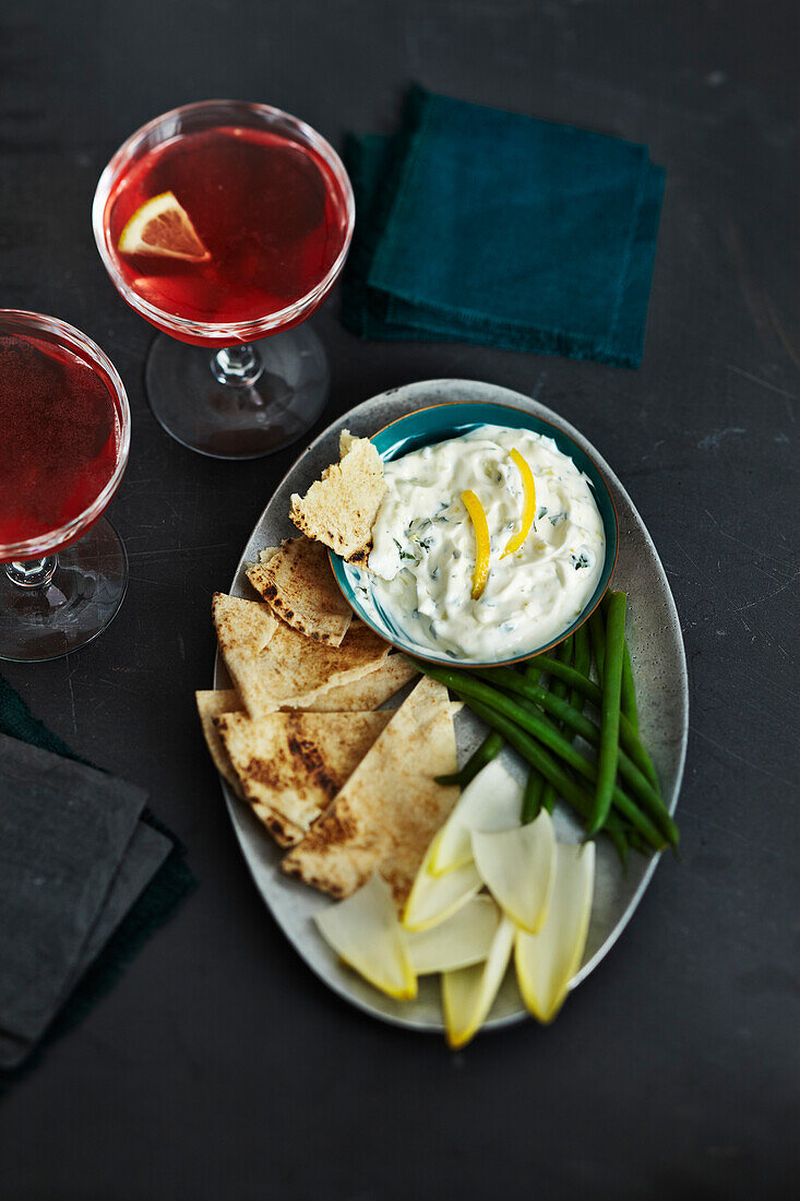 Overhead View of Cocktails and Pita Bread and Vegetables with Herb Dip, Studio Shot