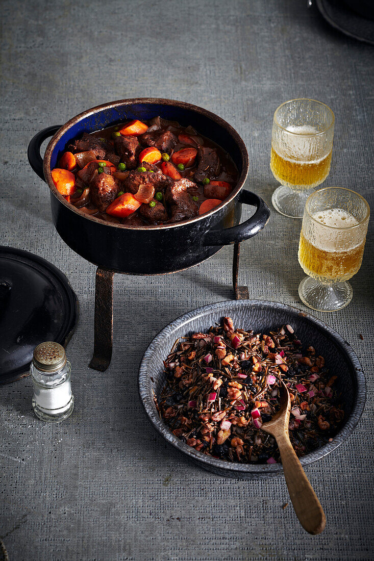 Bison Stew in Cooking Pot and Wild Rice in bowl with Beer, studio shot