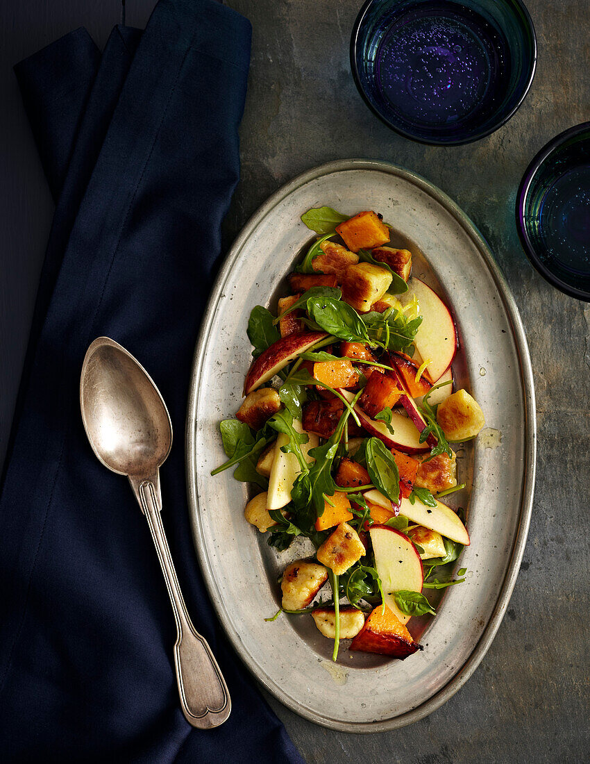 Roasted Pumpkin with Gnudi and Apples on platter, studio shot