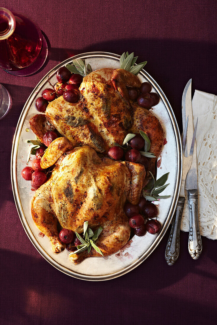 Spatchcock Roast with Grapes on platter, studio shot