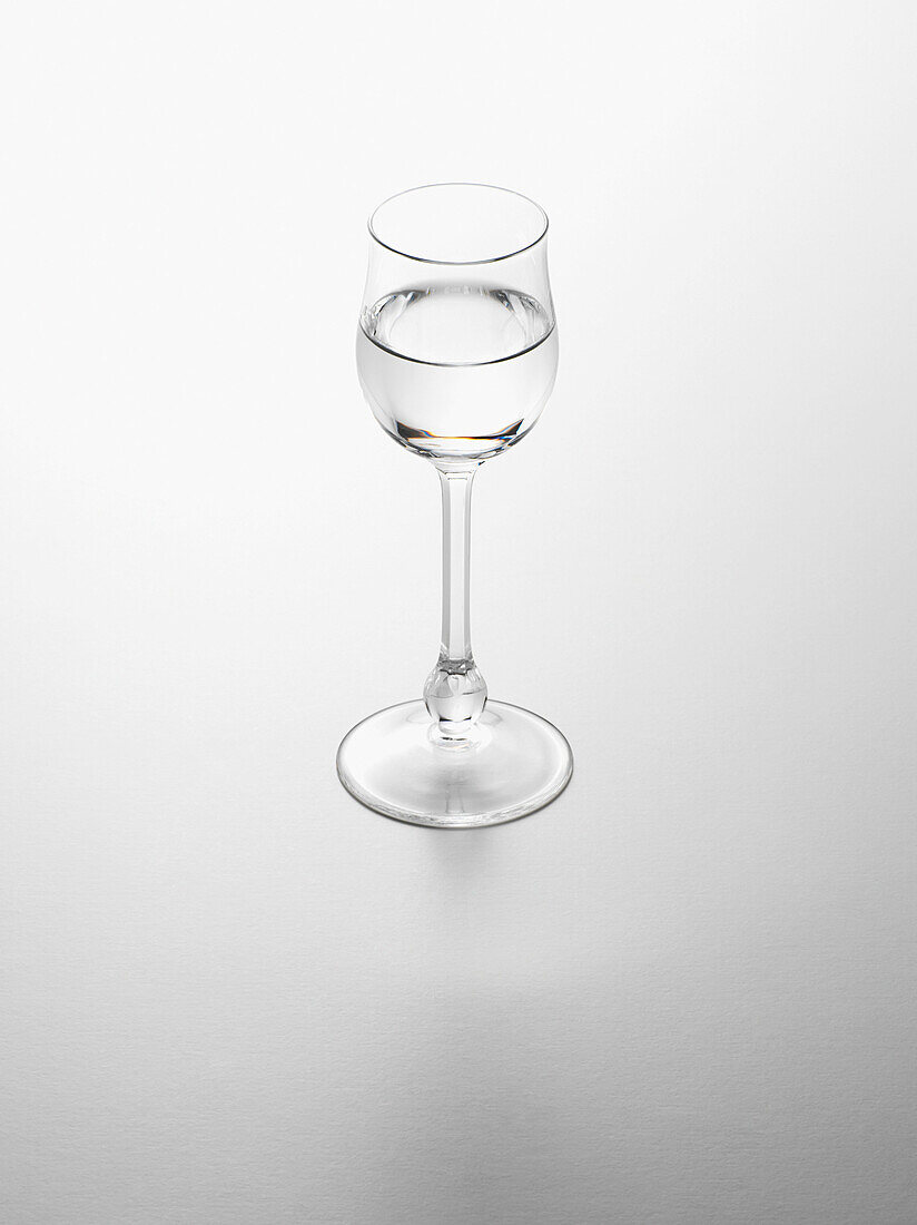Glass of Grappa on White Background, Studio Shot