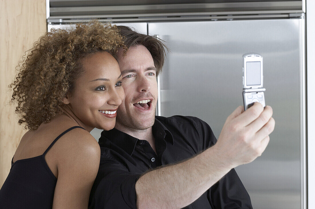 Couple Taking Pictures of Themselves With Camera Phone