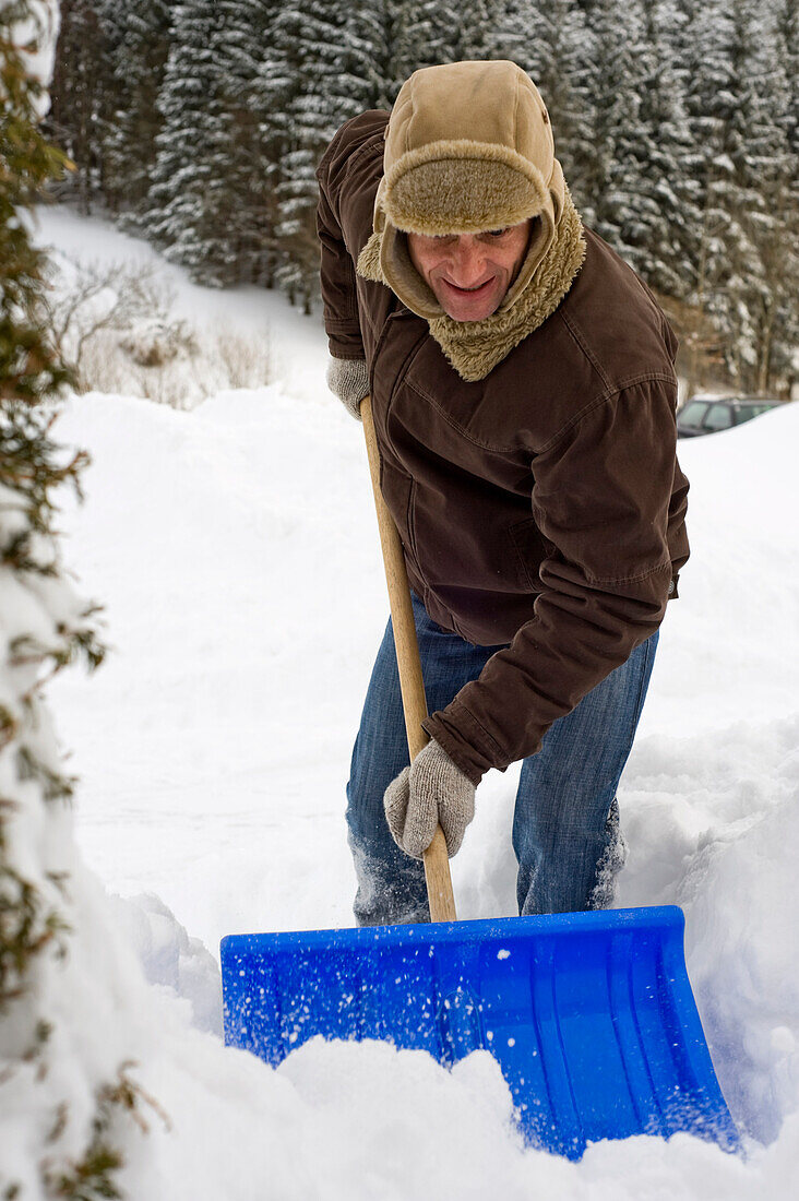 Man Shovelling Snow, Hof bei Salzburg, Austria