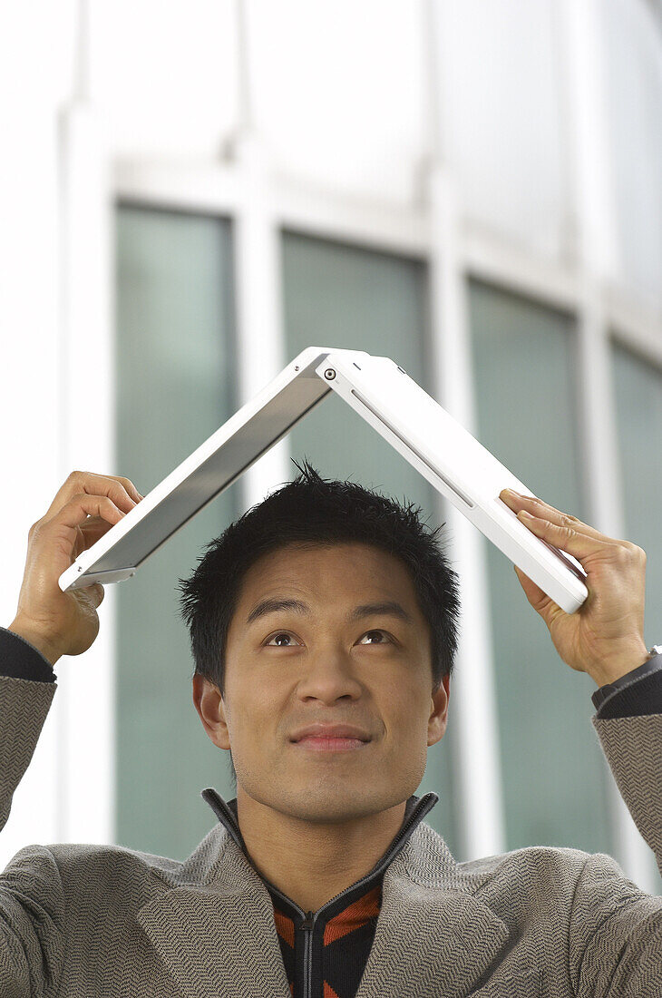 Man Using Laptop Computer For Shelter