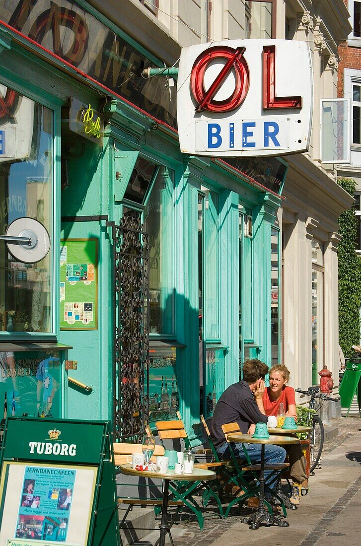 Copenhagen, Denmark; Young Couple Sitting At Sidewalk Cafe
