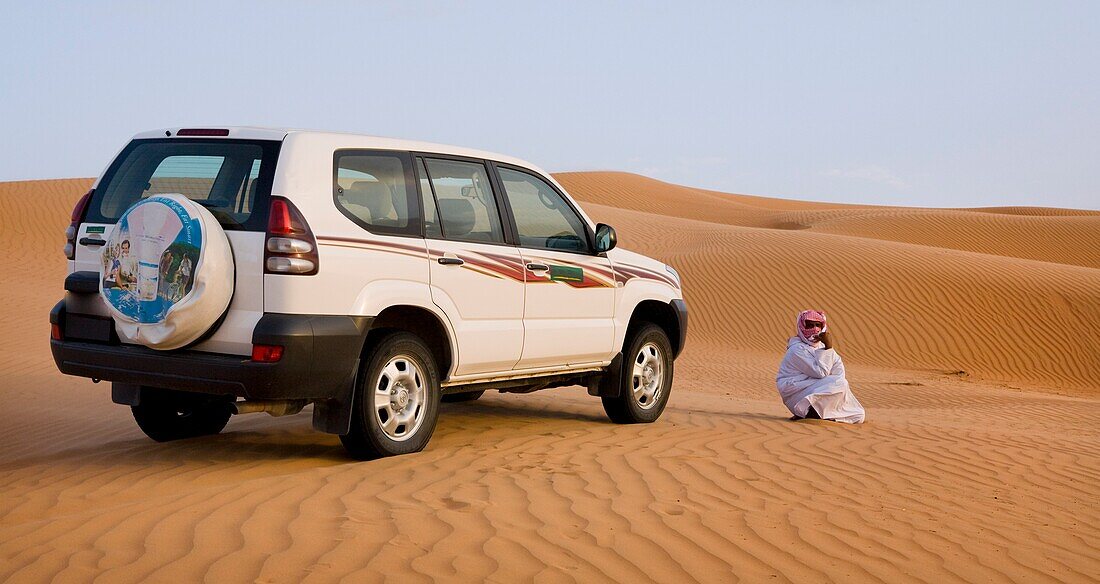 Bedu Guide Waiting By Car; Wahiba, Oman