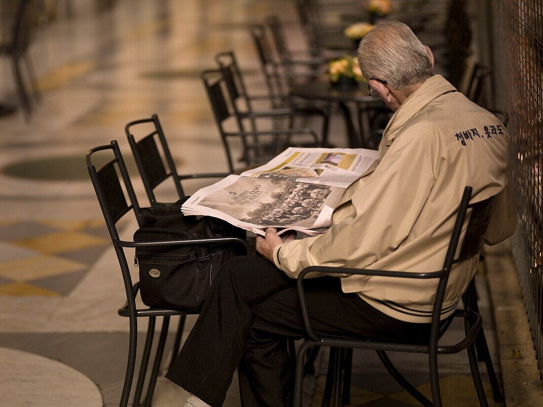 Elderly Man Reading Newspaper; Naples, Italy