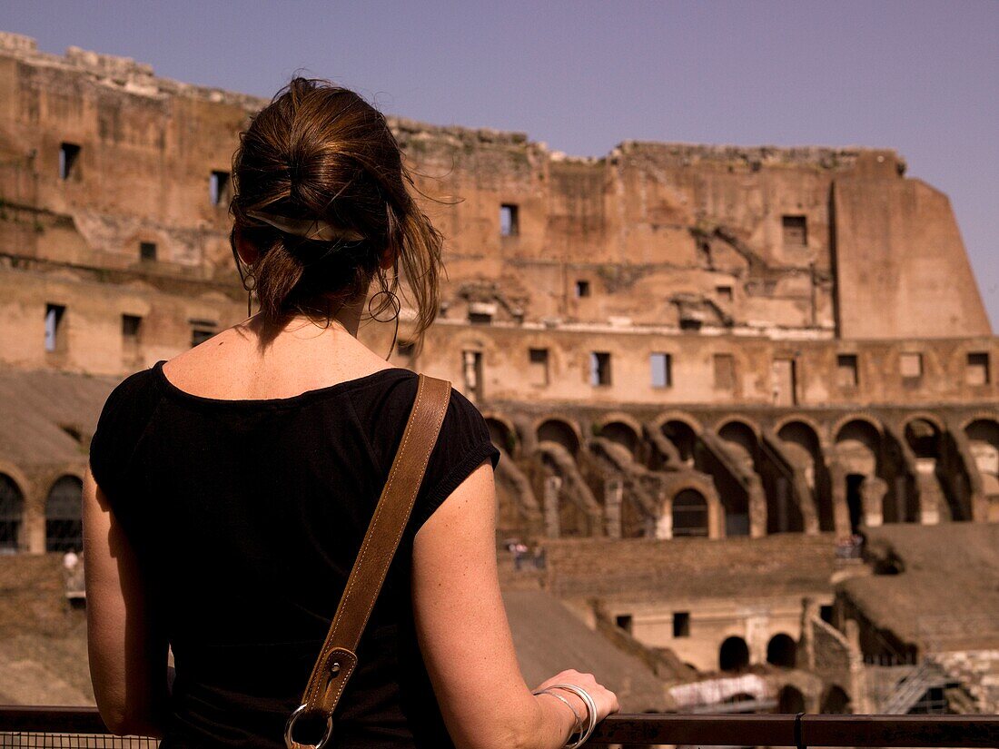 Tourist Standing In The Flavian Amphitheater (Colosseum); Rome, Italy