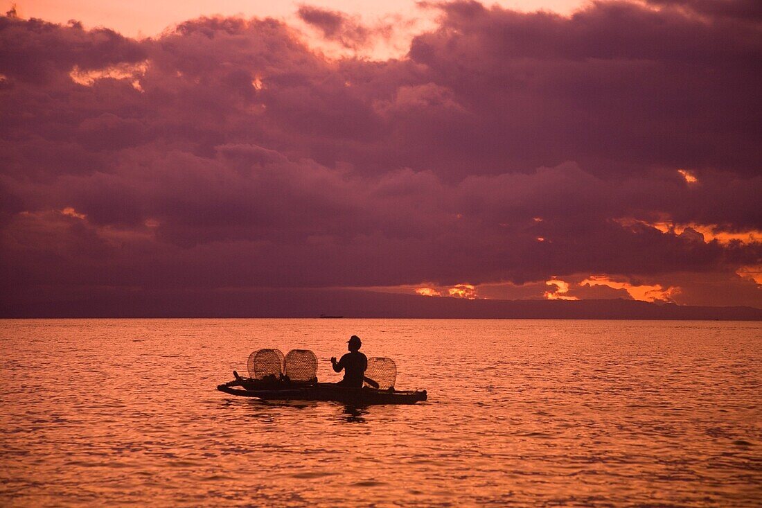 Fisherman With Baskets On Sea At Sunset; Dumaguete, Oriental Negros Island, Philippines