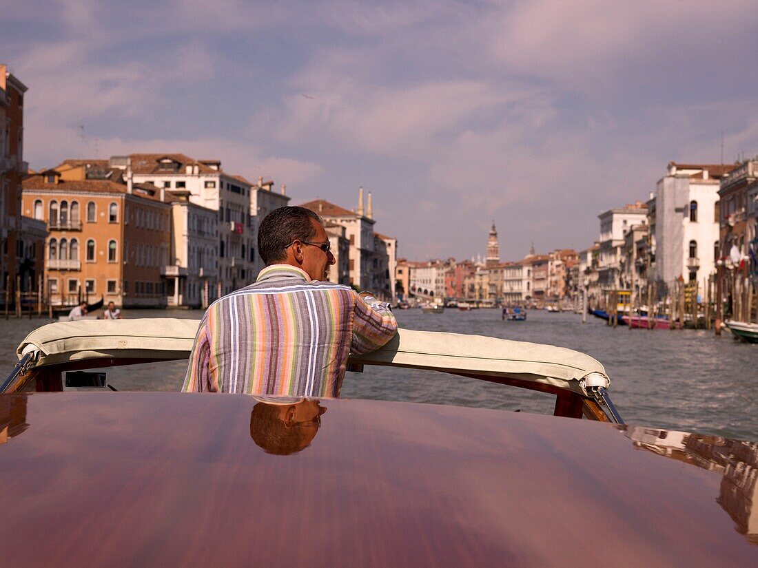 Man Standing In Motorboat; Venice, Italy