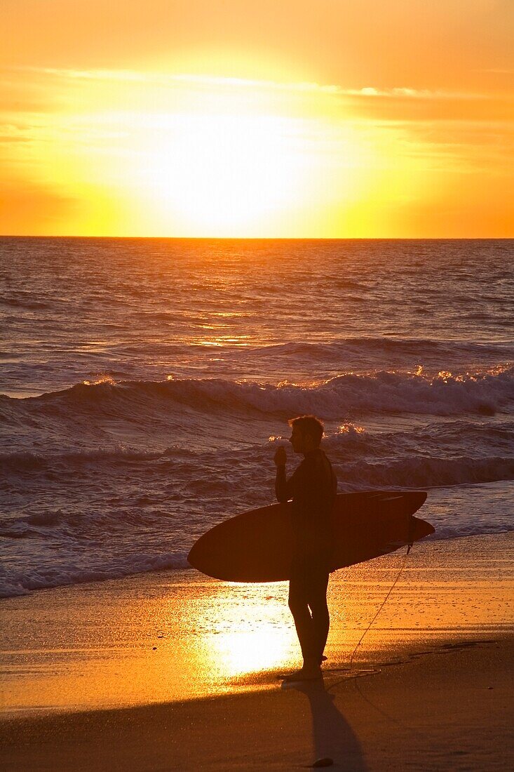 Surfer Enjoying Sunset At San Clemente Beach; San Clemente, California, Usa