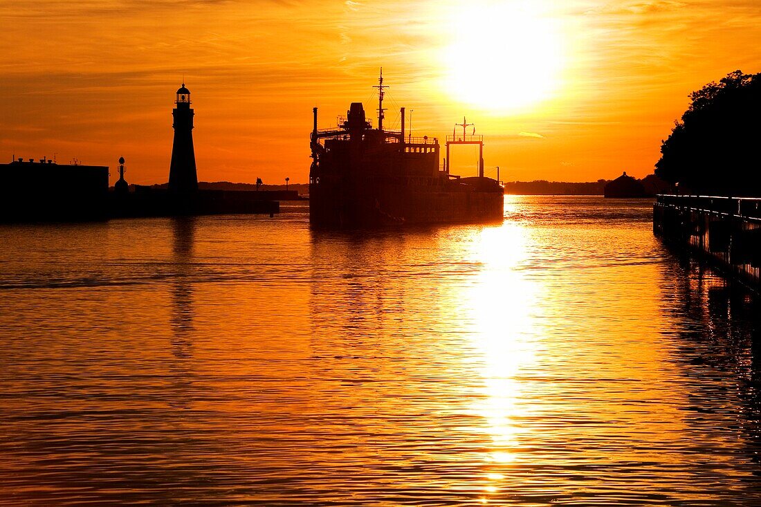 Buffalo Lighthouse And Cement Carrier In Buffalo Port At Sunset; Buffalo, New York State, Usa