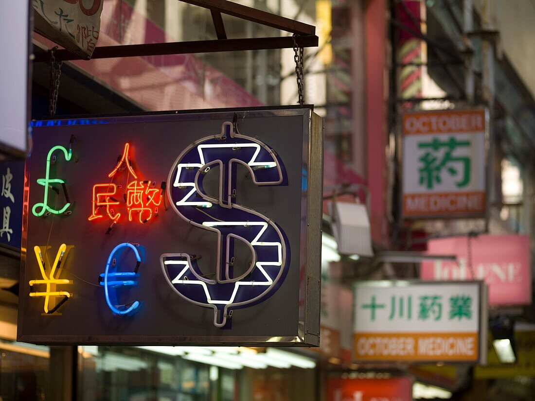 Neon Currency Sign On Street; Hong Kong, China