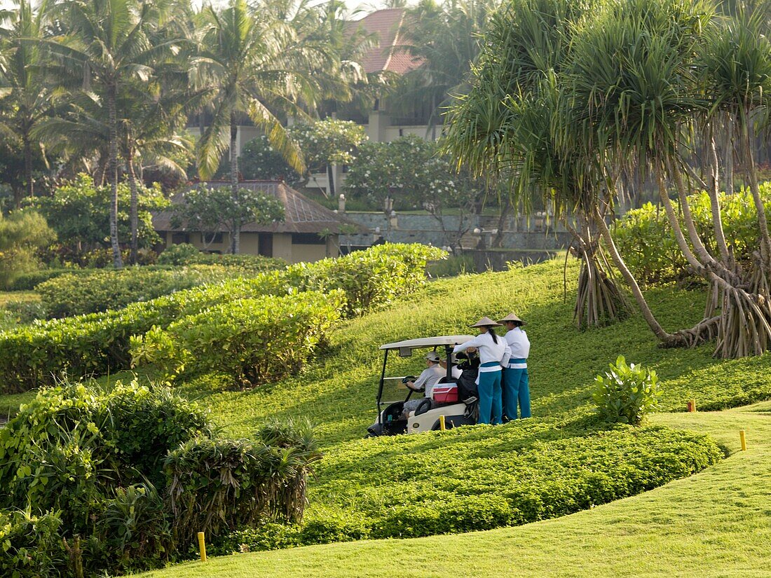 People In Golf Cart On Golf Course