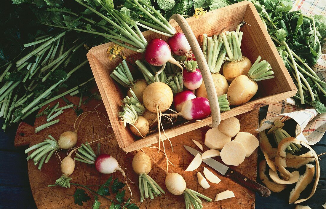 Swedes and turnips in a wooden basket and on a board