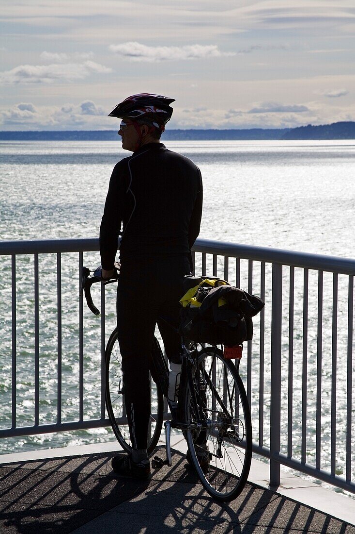 Cyclist On Bell Street Pier; Seattle, Washington State, Usa