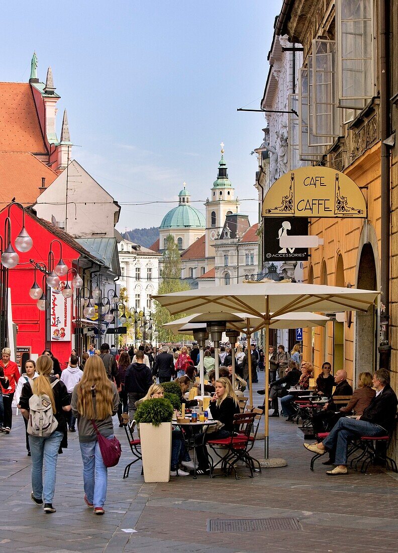 People At A Street Cafe In A Busy City