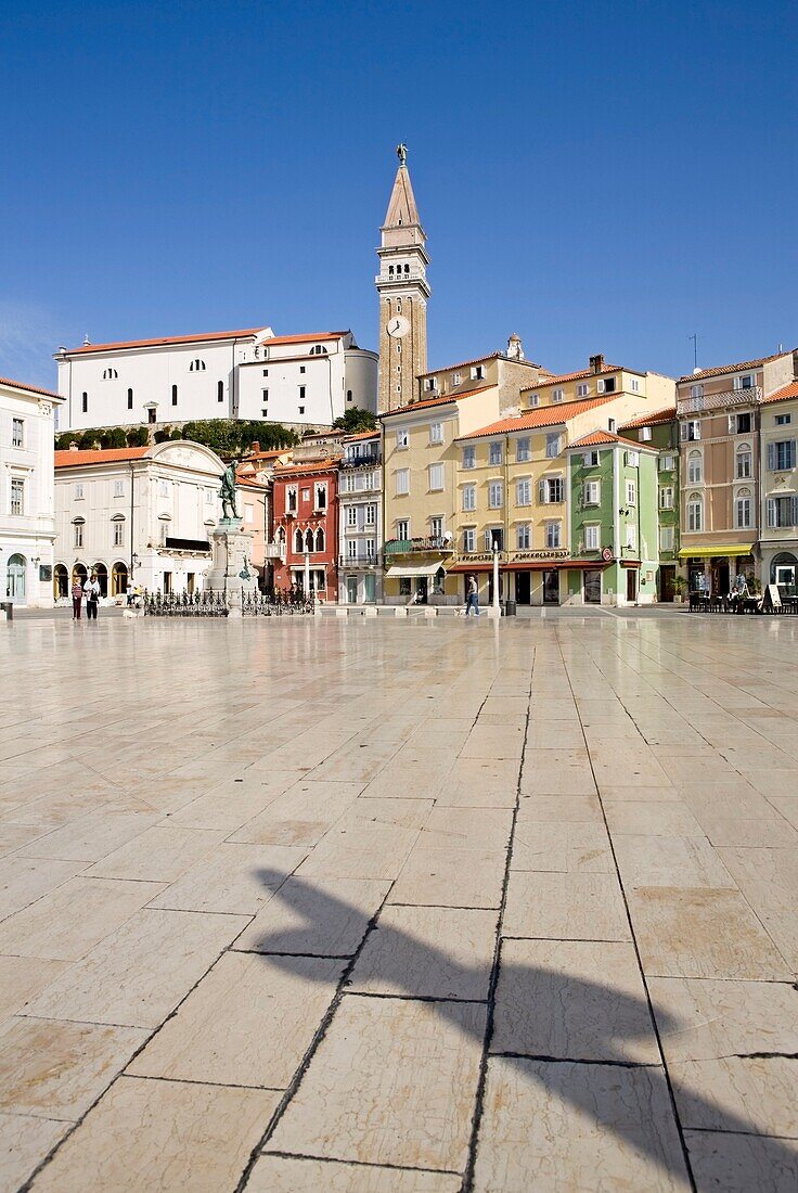 A Clock Tower Amidst Buildings In A City