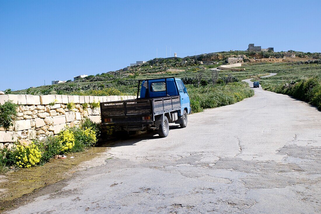 A Truck Parked On The Side Of A Rural Road