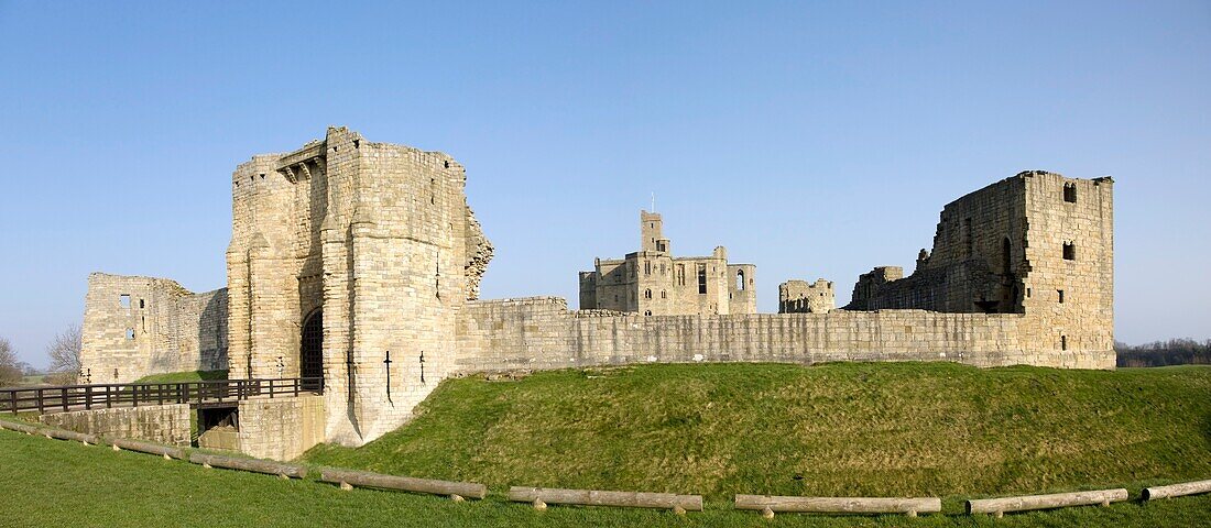 A Stone Building With Bridge And Gate