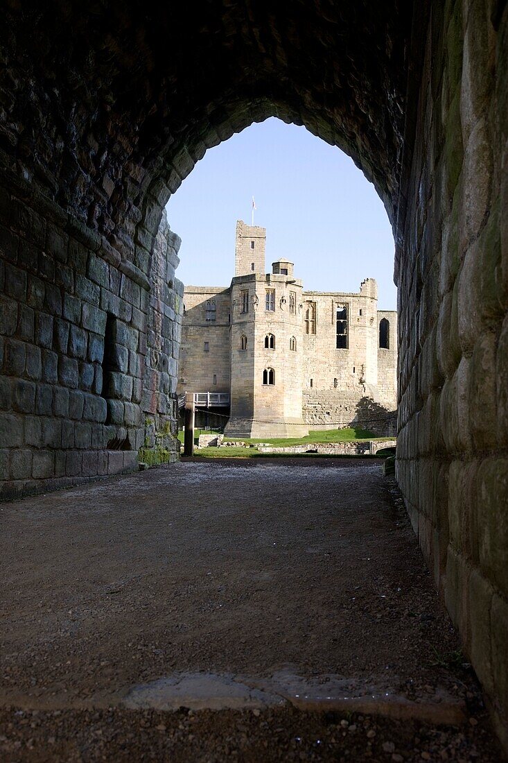 A Stone Building Through A Tunnel