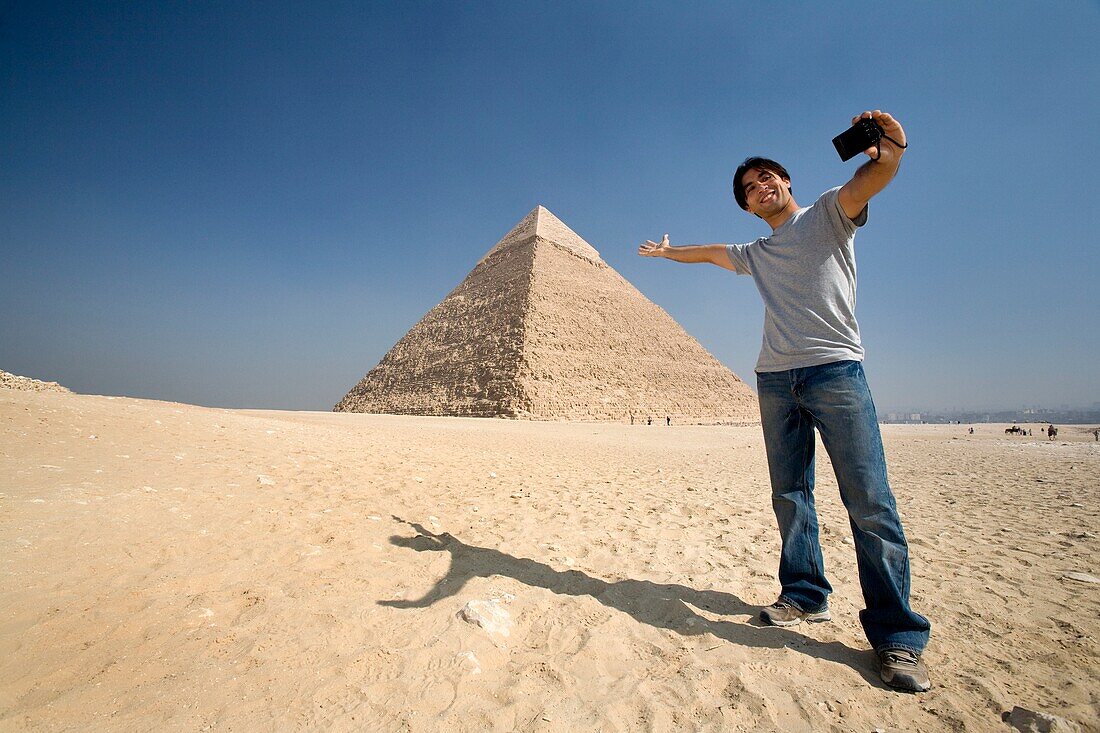 Man Taking A Picture Of Himself With Pyramid In Background