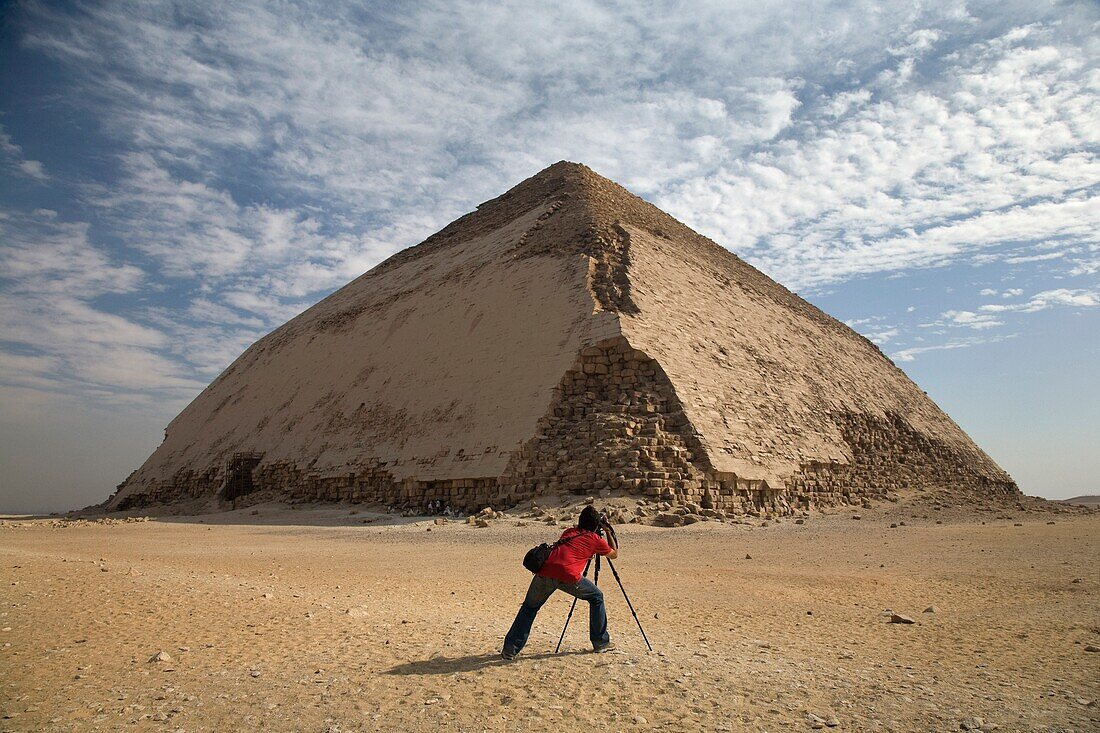 A Man Taking A Picture Of A Pyramid
