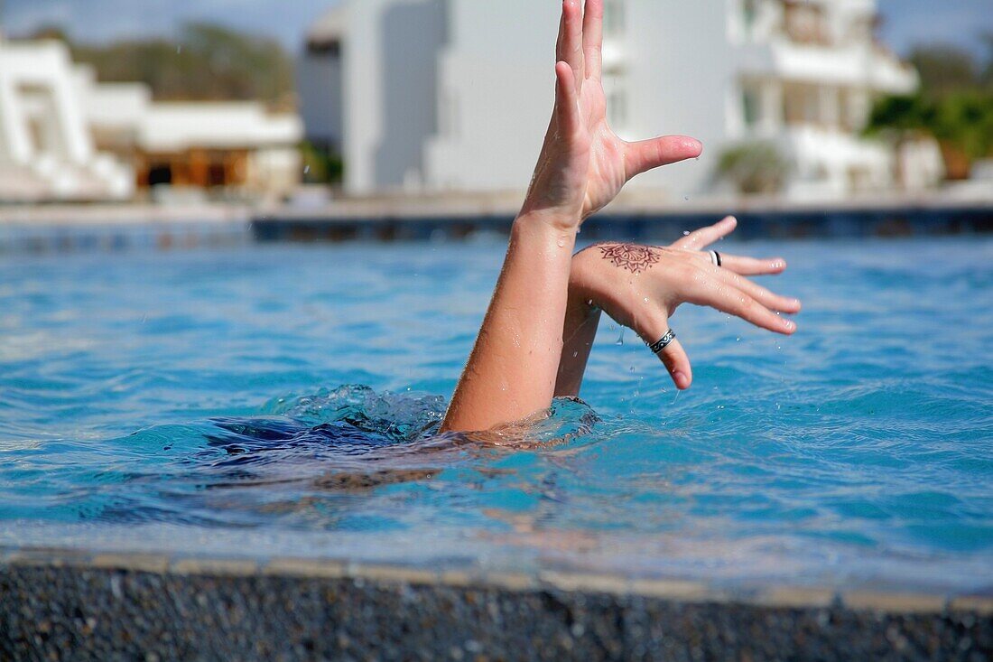 Hände mit Henna-Tattoo, die aus dem Pool kommen, Cabo San Lucas, Mexiko