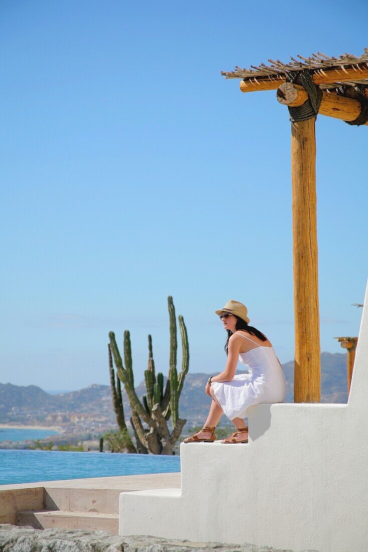 Junge Frau auf der Terrasse am Pool, Cabo San Lucas, Mexiko