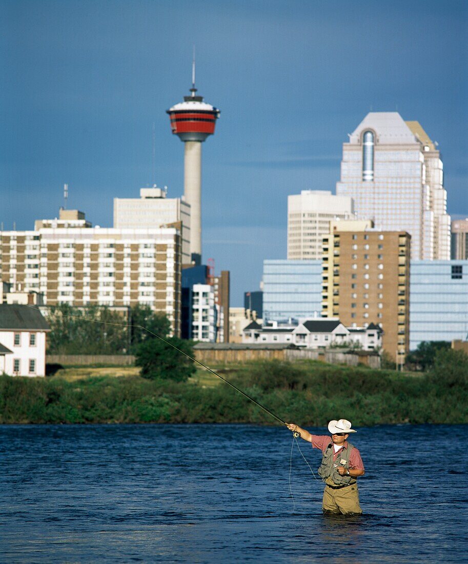 Man Fishing In The Bow River, Calgary, Alberta, Canada