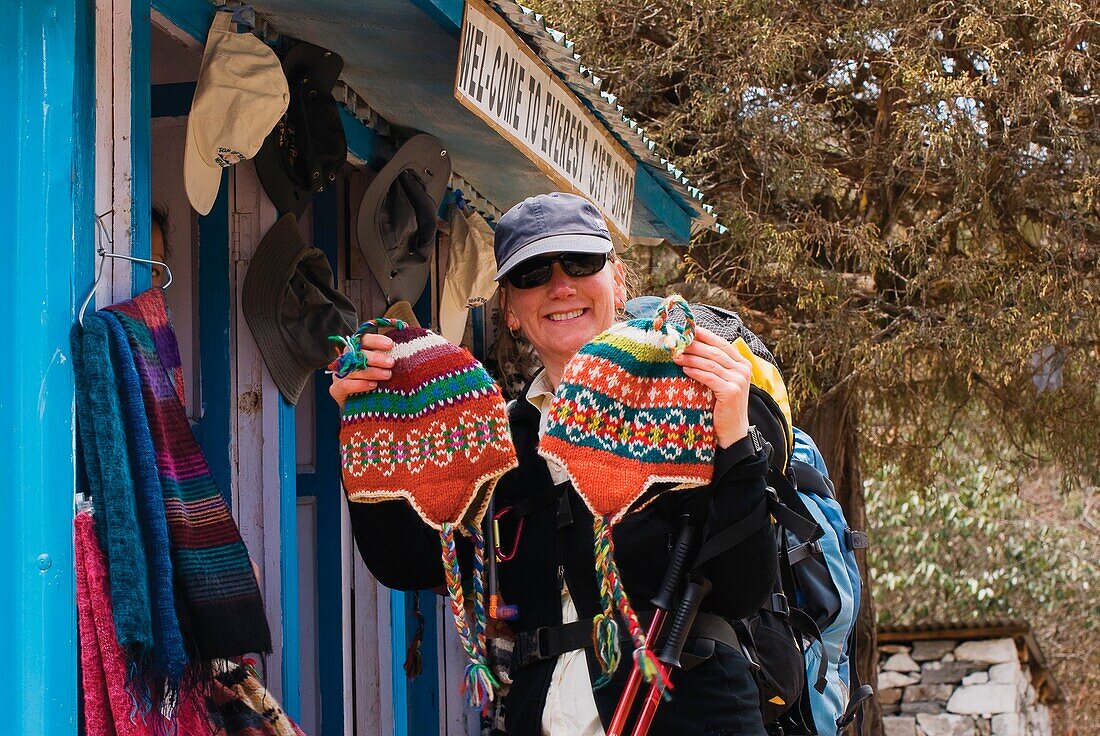 Woman Buying Woolen Hats From Gift Shop
