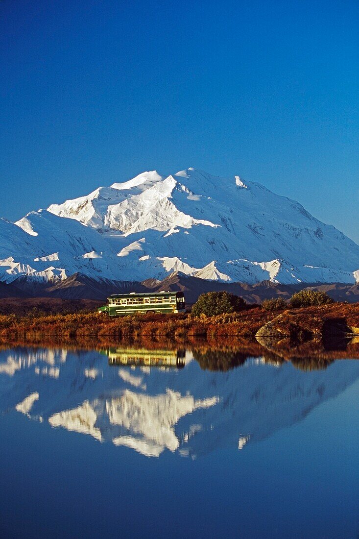 Visitor Bus Passes Along Tundra Pond With Reflection Of Mount Mckinley; Alaska,Usa