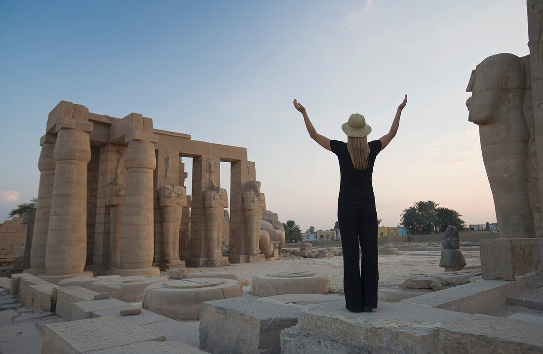 Woman Tourist With Arms Raised At The Ramesseum; Egypt,Africa