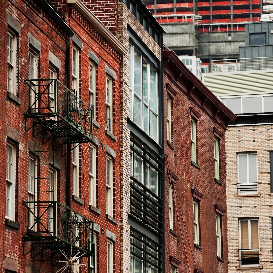 The Side Of A Brick Building With Fire Escapes