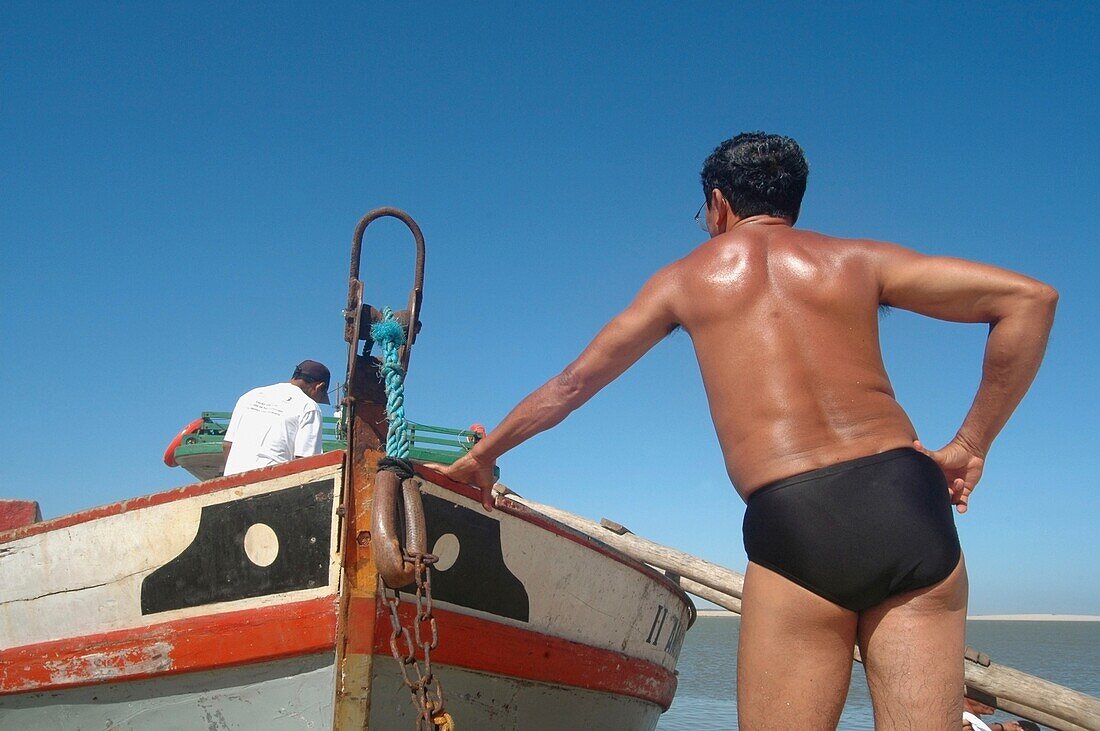 Fisherman Standing By Boat