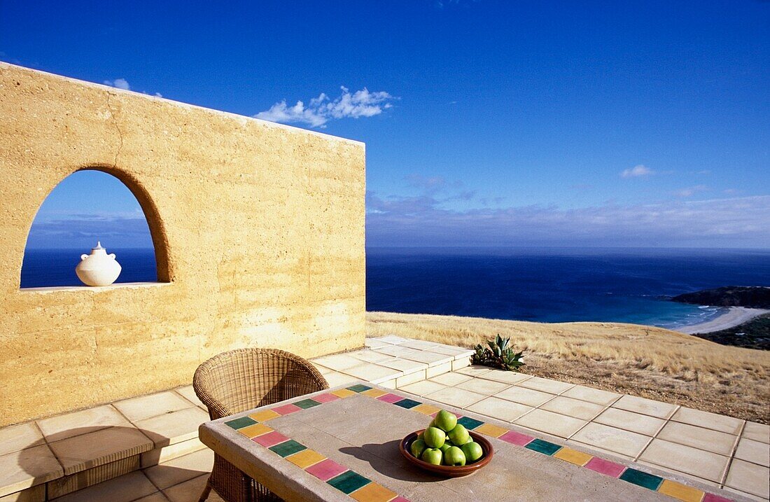 Table And Chair On Patio Overlooking Coastline