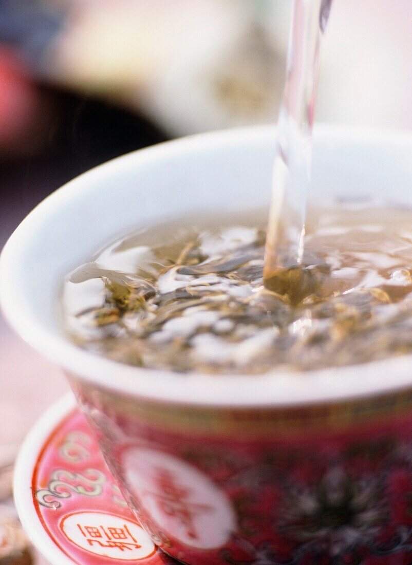 Tea Being Poured Into Tea Cup, Close Up